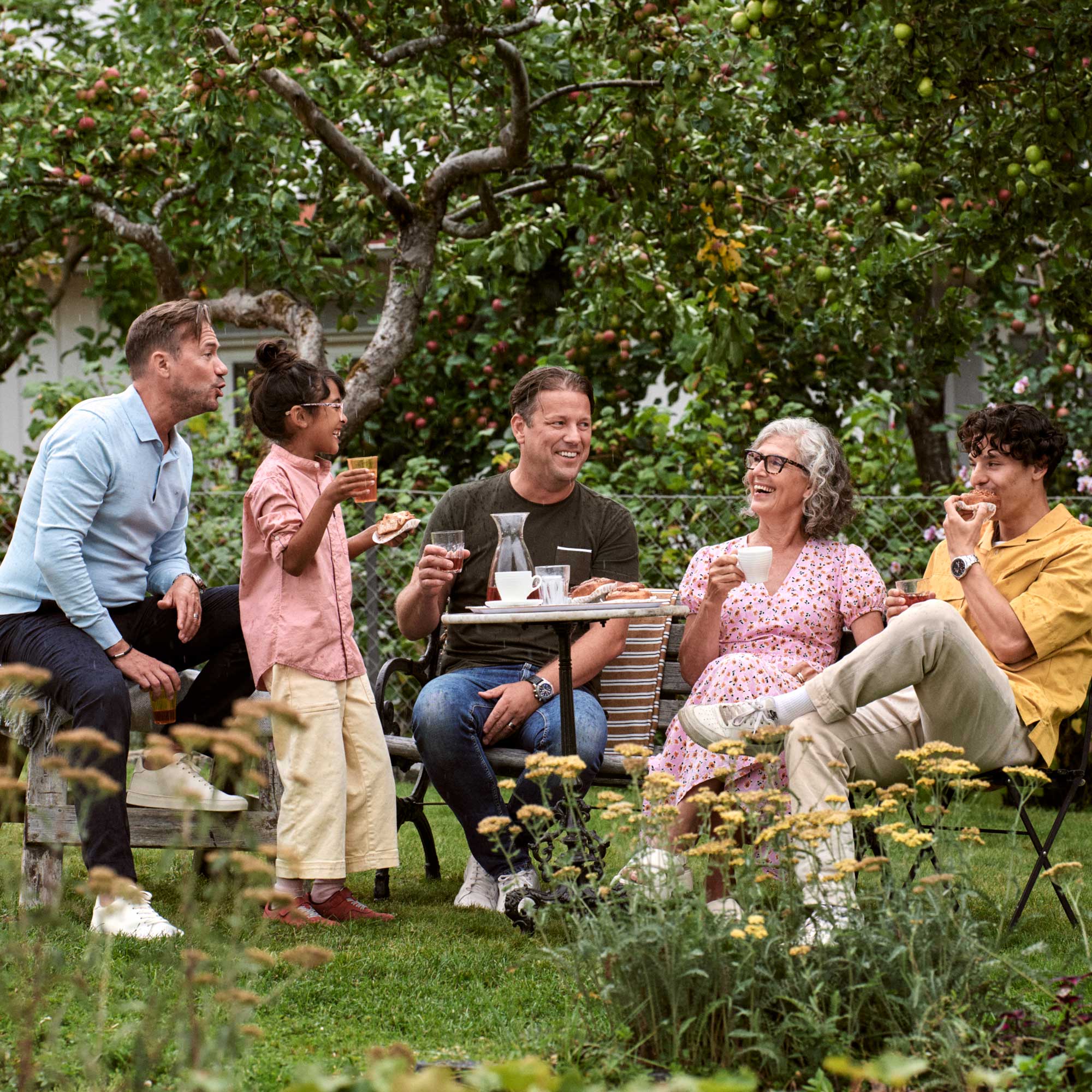 family drinking coffee in a garden