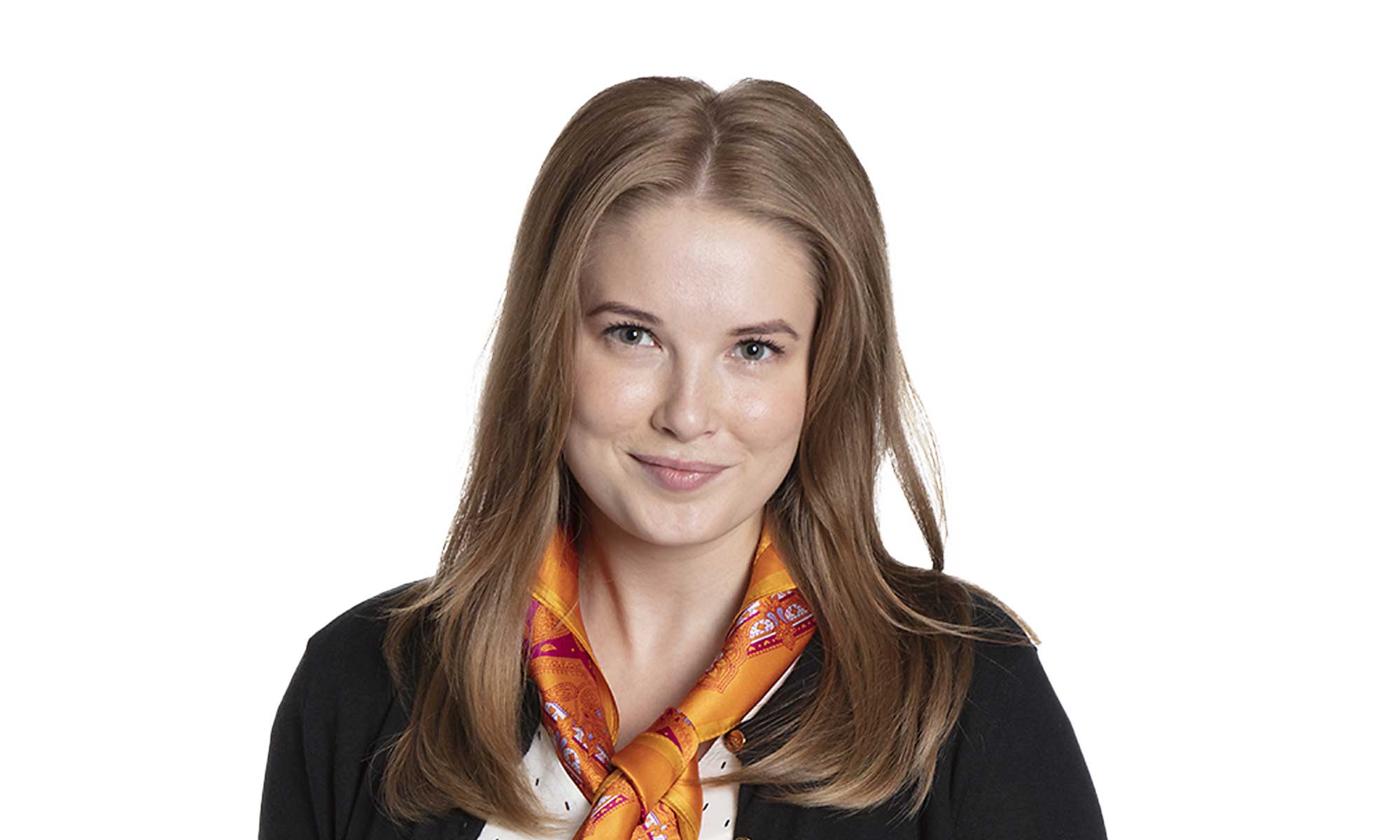 a women with blond hair dressed in a white shirt and a black jacket is looking into the camera